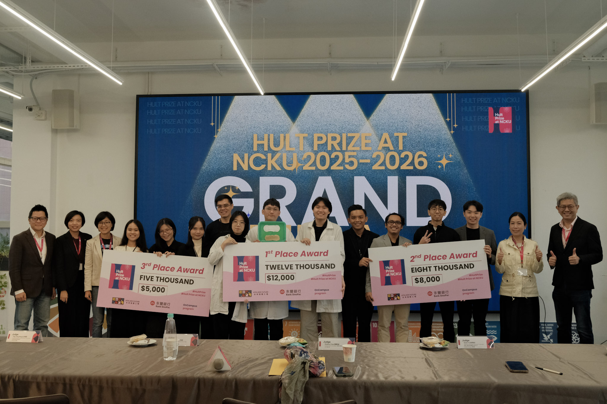 Finalist teams and judges gathered on stage for a group photo after the Award Ceremony, celebrating the Top 3 teams and marking the successful conclusion of the Hult Prize at NCKU 2025-2026 Grand Final.